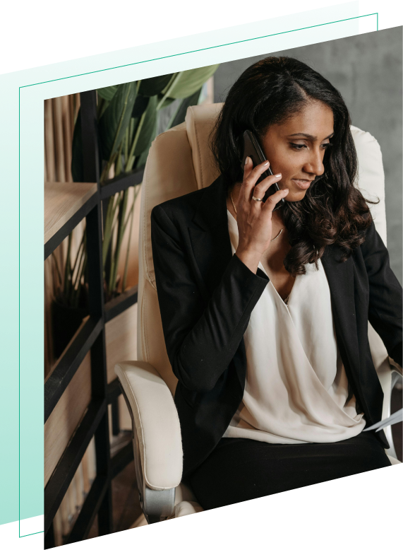 Women sitting in a chair while on the phone