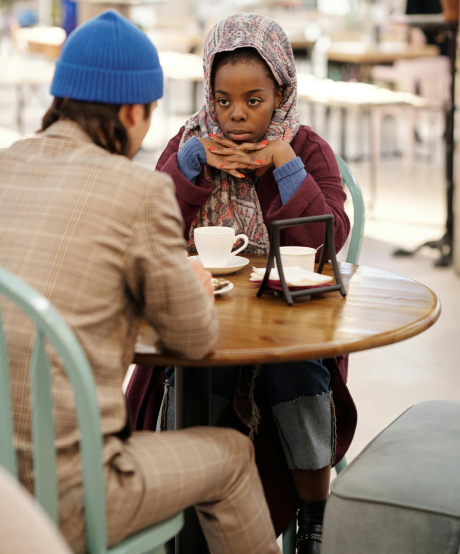 Couple having a deep conversation about their relationship at a coffee table Couple having a deep conversation about their relationship at a coffee table