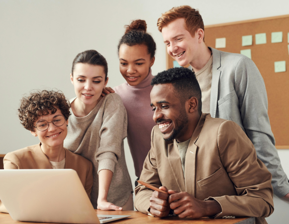 Group of coworkers looking at laptop Group of coworkers looking at laptop