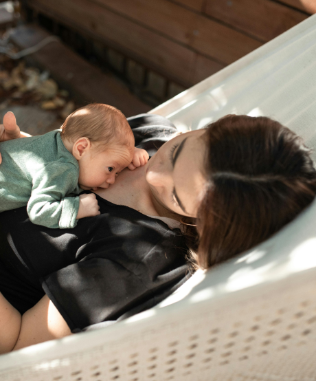 Mother laying in hammock with baby Mother laying in hammock with baby
