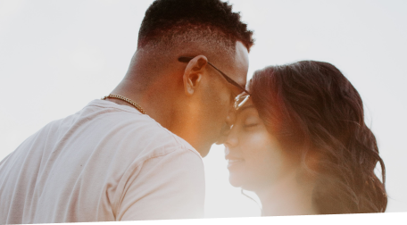 Happy couple embracing while the sun is setting