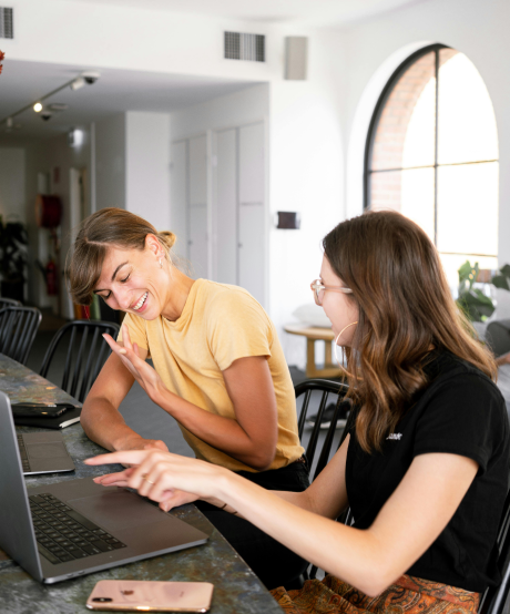 Two women sitting and talking at kitchen counter Two women sitting and talking at kitchen counter