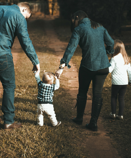 Young family walking on a dirt pathway Young family walking on a dirt pathway